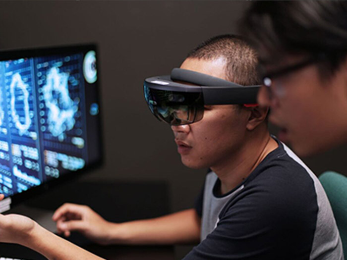 young man with black shirt and virtual headset plays games